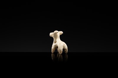 Lot 62 - A WHITE GLAZED XINGYAO POTTERY TOGGLE IN THE FORM OF A DEER, SONG DYNASTY