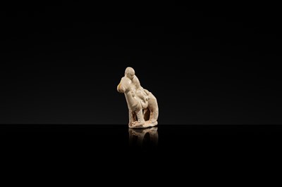 Lot 56 - A SMALL WHITE GLAZED CIZHOU FIGURE OF A BOY ON HORSEBACK, LIAO DYNASTY