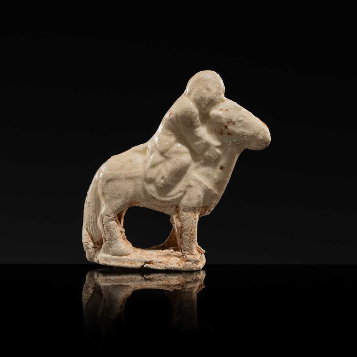 Lot 56 - A SMALL WHITE GLAZED CIZHOU FIGURE OF A BOY ON HORSEBACK, LIAO DYNASTY