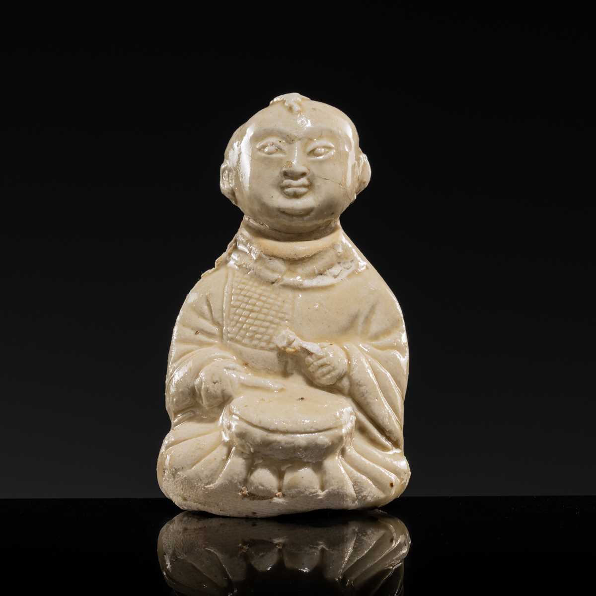A RARE DINGYAO STONEWARE FIGURE OF A BOY DRUMMER, SONG DYNASTY
