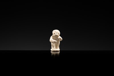 A SMALL WHITE GLAZED DINGYAO FIGURE OF A MONKEY, NORTHERN SONG DYNASTY