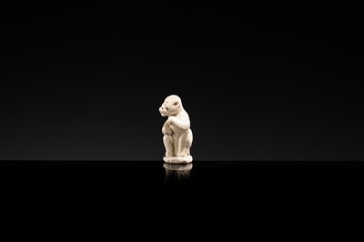 A SMALL WHITE GLAZED DINGYAO FIGURE OF A MONKEY, NORTHERN SONG DYNASTY