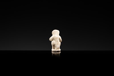 A SMALL WHITE GLAZED DINGYAO FIGURE OF A MONKEY, NORTHERN SONG DYNASTY