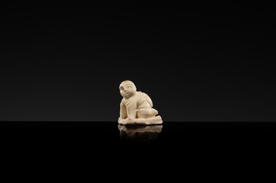 A WHITE GLAZED DINGYAO MINIATURE FIGURE OF A CRAWLING TODDLER (HEJI), NORTHERN SONG DYNASTY