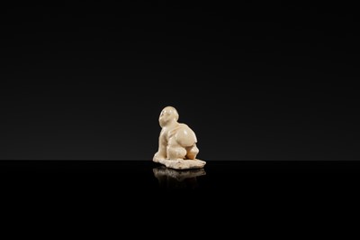 A WHITE GLAZED DINGYAO MINIATURE FIGURE OF A CRAWLING TODDLER (HEJI), NORTHERN SONG DYNASTY