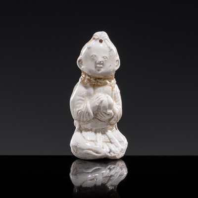 Lot 84 - A SMALL WHITE GLAZED DINGYAO FIGURE OF A SEATED CHILD HOLDING A GOURD, SONG DYNASTY