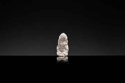 Lot 85 - A SMALL WHITE GLAZED DINGYAO FIGURE OF A BOY CARRYING A TODDLER, NORTHERN SONG DYNASTY