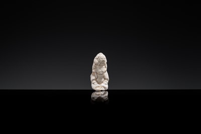 Lot 85 - A SMALL WHITE GLAZED DINGYAO FIGURE OF A BOY CARRYING A TODDLER, NORTHERN SONG DYNASTY