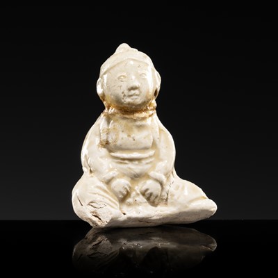 Lot 79 - A SMALL WHITE GLAZED DINGYAO FIGURE OF A SEATED BOY, NORTHERN SONG DYNASTY