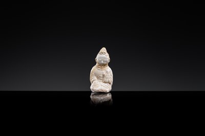 Lot 59 - A SMALL WHITE GLAZED DINGYAO FIGURE OF A SEATED GIRL HOLDING A DOLL, EARLY SONG TO EARLY LIAO DYNASTY