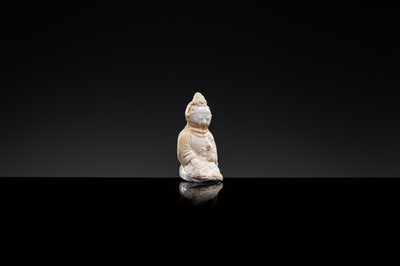 Lot 59 - A SMALL WHITE GLAZED DINGYAO FIGURE OF A SEATED GIRL HOLDING A DOLL, EARLY SONG TO EARLY LIAO DYNASTY