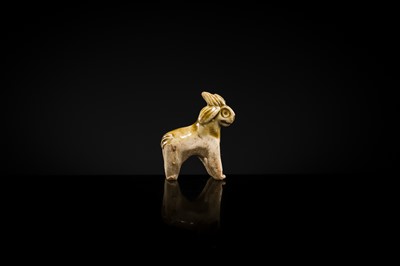 Lot 65 - A MOTTLED YELLOWISH-WHITE GLAZED MINIATURE FIGURE OF A GOAT, SONG DYNASTY