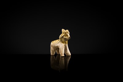 Lot 65 - A MOTTLED YELLOWISH-WHITE GLAZED MINIATURE FIGURE OF A GOAT, SONG DYNASTY