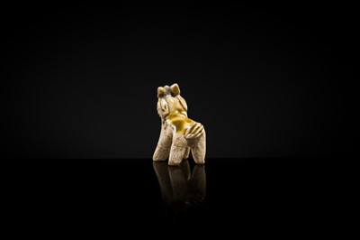 Lot 65 - A MOTTLED YELLOWISH-WHITE GLAZED MINIATURE FIGURE OF A GOAT, SONG DYNASTY