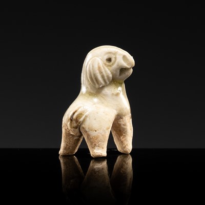 Lot 66 - A MOTTLED WHITE GLAZED DINGYAO MINIATURE FIGURE OF A DOG, SONG DYNASTY