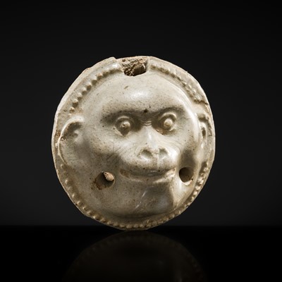 Lot 48 - A GLAZED POTTERY WHISTLE IN THE FORM OF A MONKEY’S HEAD, FIVE DYNASTIES PERIOD