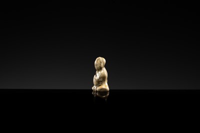 A YAOZHOU STONEWARE FIGURE OF A GIRL WITH A MELON, NORTHERN SONG DYNASTY