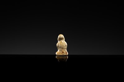 A YAOZHOU STONEWARE FIGURE OF A GIRL WITH A MELON, NORTHERN SONG DYNASTY