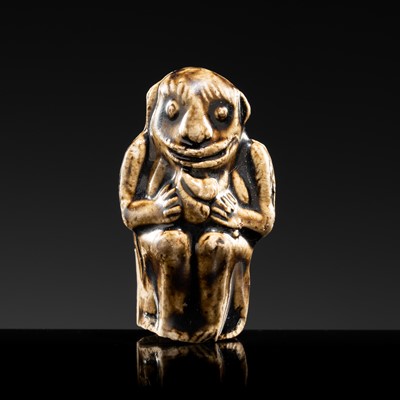 A BROWN GLAZED STONEWARE WHISTLE IN THE FORM OF A MONKEY HOLDING A PEACH, SONG TO JIN DYNASTY