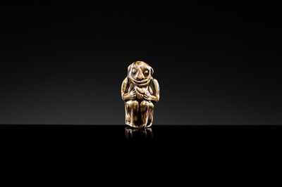 A BROWN GLAZED STONEWARE WHISTLE IN THE FORM OF A MONKEY HOLDING A PEACH, SONG TO JIN DYNASTY