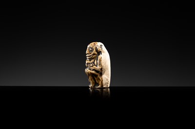 A BROWN GLAZED STONEWARE WHISTLE IN THE FORM OF A MONKEY HOLDING A PEACH, SONG TO JIN DYNASTY