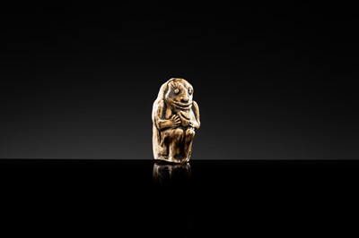 A BROWN GLAZED STONEWARE WHISTLE IN THE FORM OF A MONKEY HOLDING A PEACH, SONG TO JIN DYNASTY