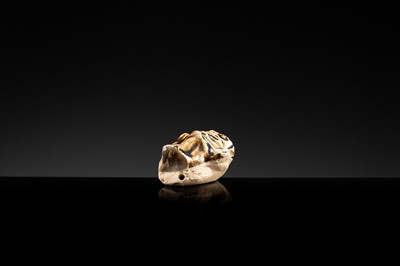 A BROWN GLAZED STONEWARE WHISTLE IN THE FORM OF A MONKEY HOLDING A PEACH, SONG TO JIN DYNASTY