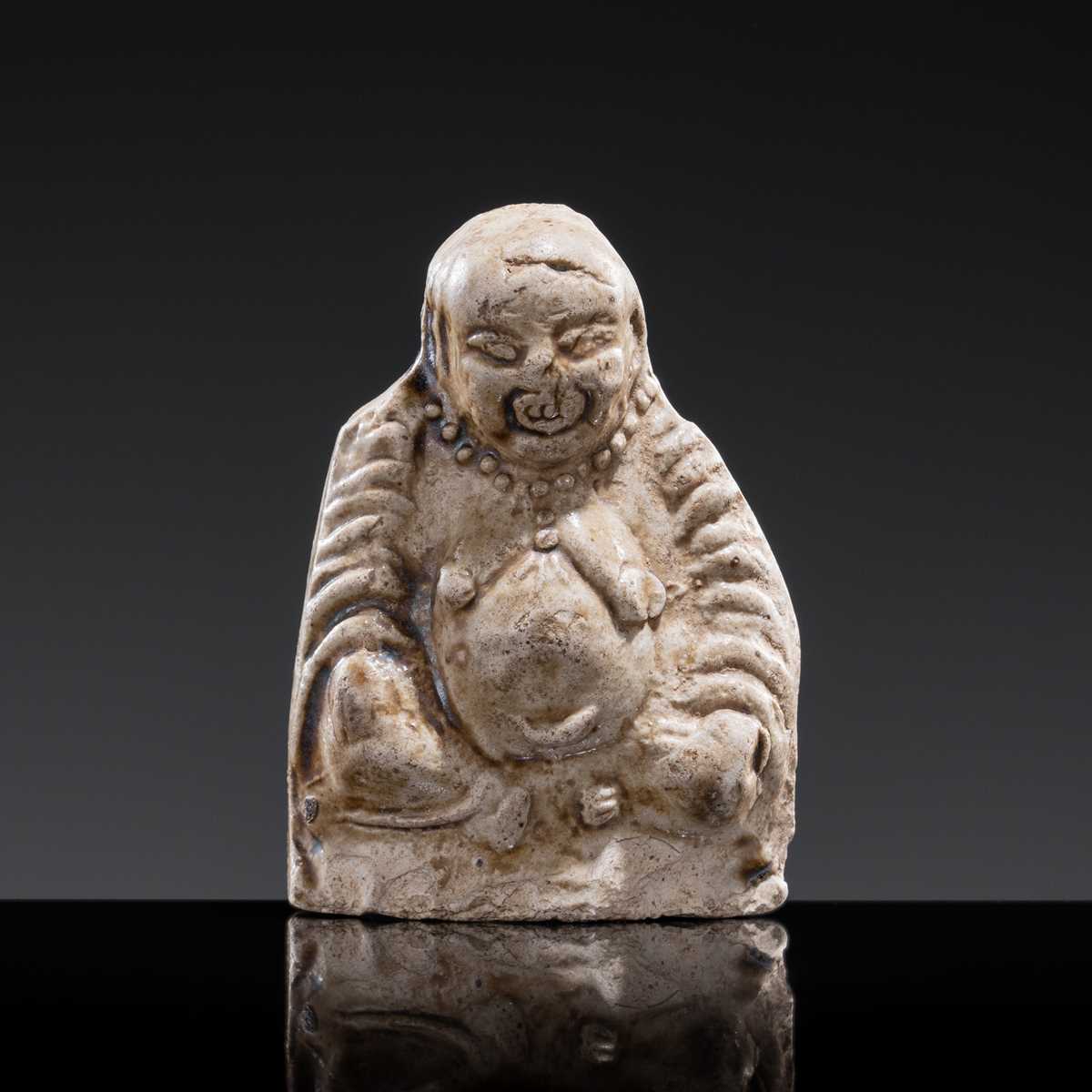 A BROWN GLAZED POTTERY WHISTLE OF A PROTECTIVE DEITY, JIN DYNASTY