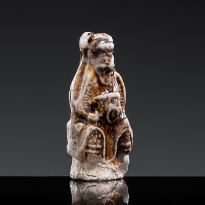 A 'DAOIST OFFICIAL' BROWN-GLAZED POTTERY WHISTLE, JIN DYNASTY