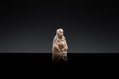 A BROWN-GLAZED POTTERY WHISTLE IN THE FORM OF A DEITY, JIN DYNASTY