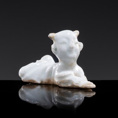 Lot 87 - A SMALL QINGBAI GLAZED PORCELAIN FIGURE OF A RECLINING BOY, SONG DYNASTY