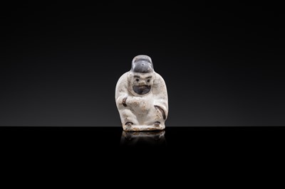 A WHITE AND DARK BROWN GLAZED STONEWARE FIGURE OF AN OFFICIAL, YUAN DYNASTY