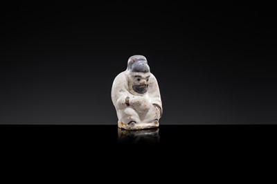A WHITE AND DARK BROWN GLAZED STONEWARE FIGURE OF AN OFFICIAL, YUAN DYNASTY