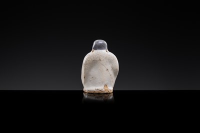 A WHITE AND DARK BROWN GLAZED STONEWARE FIGURE OF AN OFFICIAL, YUAN DYNASTY