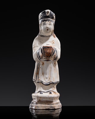 Lot 124 - A PAINTED CIZHOU WARE FIGURE OF A TRIBUTE BEARER, YUAN DYNASTY