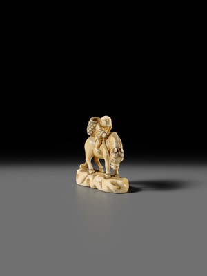 Lot 86 - AN IVORY NETSUKE OF A BOY ON A HORSE