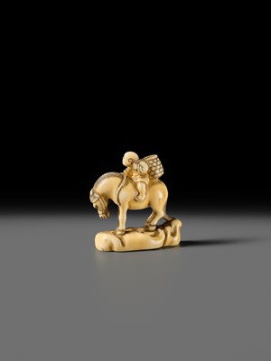 Lot 86 - AN IVORY NETSUKE OF A BOY ON A HORSE
