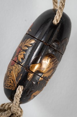 Lot 1431 - A SMALL TWO-CASE LACQUER INRO DEPICTING A SHISHI