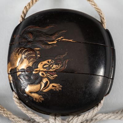 Lot 1431 - A SMALL TWO-CASE LACQUER INRO DEPICTING A SHISHI