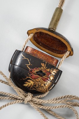 Lot 1431 - A SMALL TWO-CASE LACQUER INRO DEPICTING A SHISHI