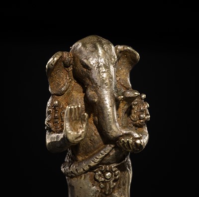 Lot 265 - A SILVER AND COPPER-ALLOY FIGURE OF GANESHA, CENTRAL JAVA, INDONESIA, 13TH CENTURY