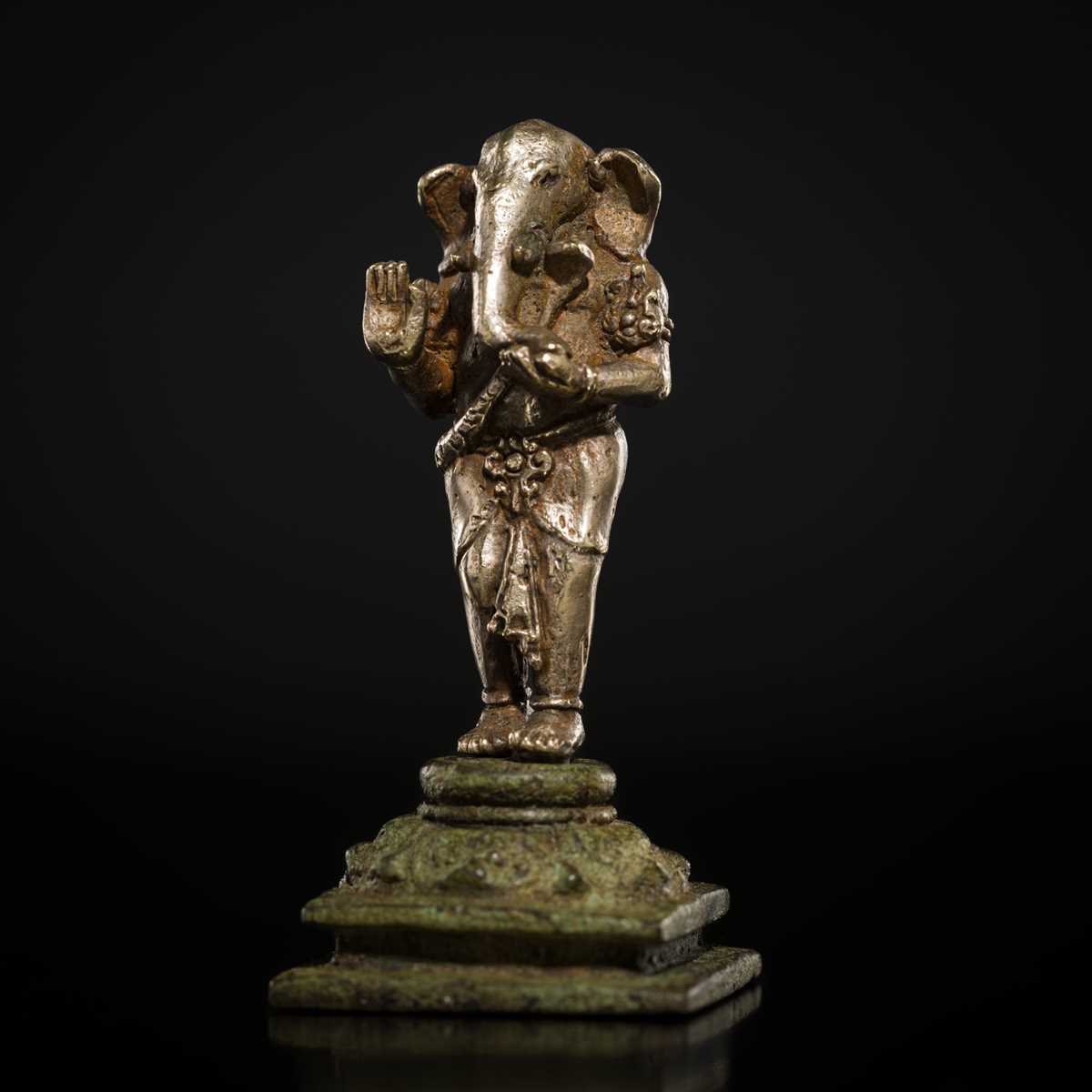Lot 265 - A SILVER AND COPPER-ALLOY FIGURE OF GANESHA, CENTRAL JAVA, INDONESIA, 13TH CENTURY