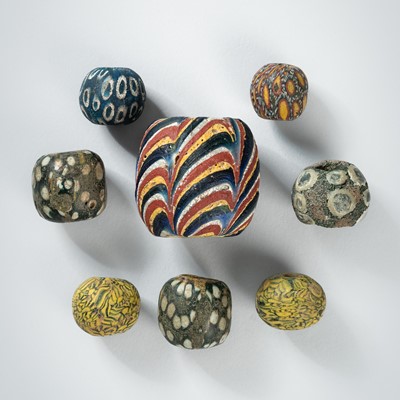 Lot 1371 - A FINE GROUP OF EIGHT ‘JATIM’ GLASS BEADS, c. 600-800 AD