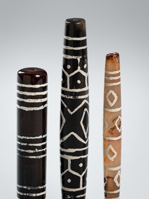 Lot 1343 - A LOT WITH THREE ETCHED PYU AGATE BEADS, c. 7TH – 9TH CENTURY