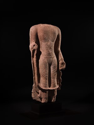 AN ICONIC RED SANDSTONE TORSO OF THE BUDDHA, GUPTA PERIOD, MATHURA, 3RD-5TH CENTURY