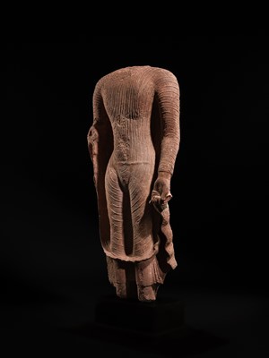 AN ICONIC RED SANDSTONE TORSO OF THE BUDDHA, GUPTA PERIOD, MATHURA, 3RD-5TH CENTURY