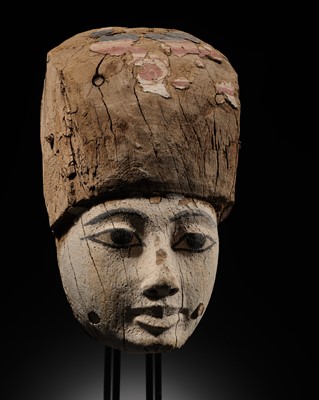 Lot 15 - AN EGYPTIAN GESSO PAINTED WOOD SARCOPHAGUS MASK, 22ND/26TH DYNASTY