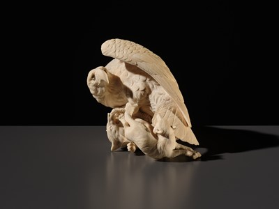TOMOKAZU: A SUPERB IVORY OKIMONO OF AN EAGLE WITH TWO FOXES