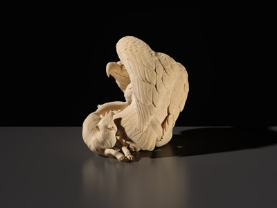 TOMOKAZU: A SUPERB IVORY OKIMONO OF AN EAGLE WITH TWO FOXES