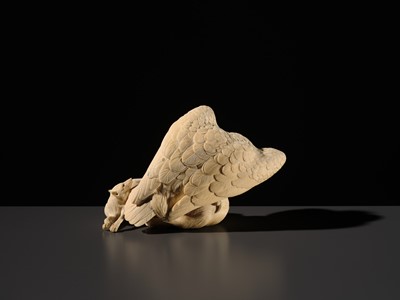 TOMOKAZU: A SUPERB IVORY OKIMONO OF AN EAGLE WITH TWO FOXES